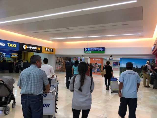 Travelers walking to the exit of Cancun Airport