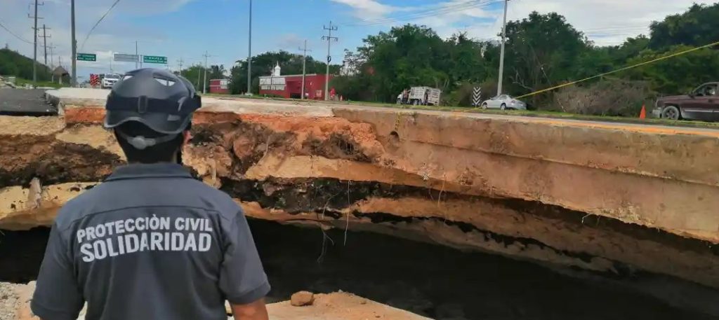 Civil Protection officer looking at road damage in Cancun - Riviera Maya road