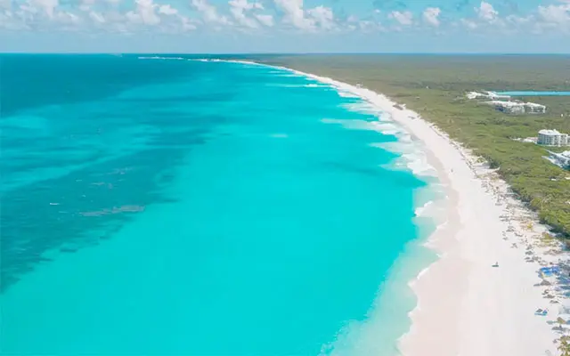 Aerial view of the turquoise beaches of Isla Blanca. One of the destinations available for Cancun Airport Transportation