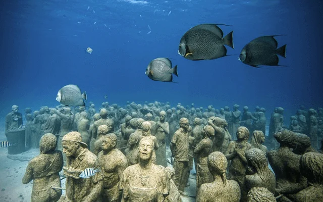 Sculptures sunk in the sea part of the Underwater Museum of Art near Isla Mujeres. One of the destinations available for Cancun Airport Transportation