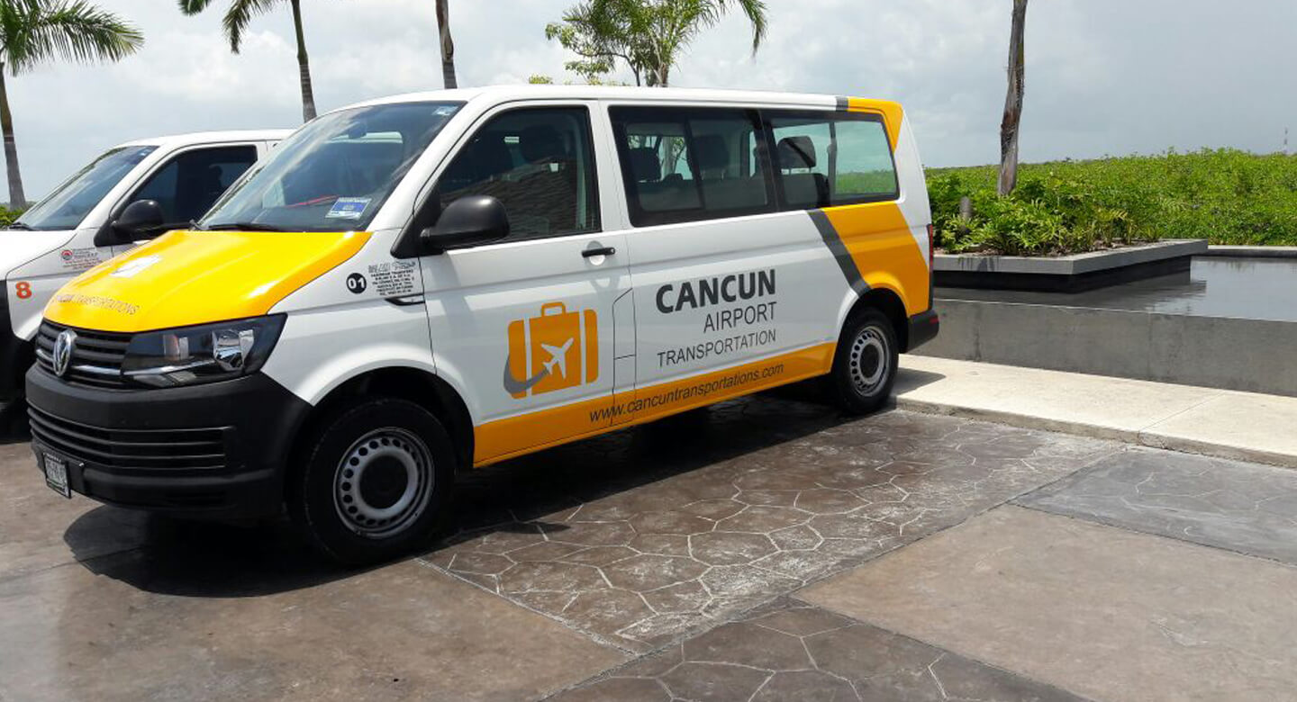Cancun Airport Transportation van parked in the outside of a hotel