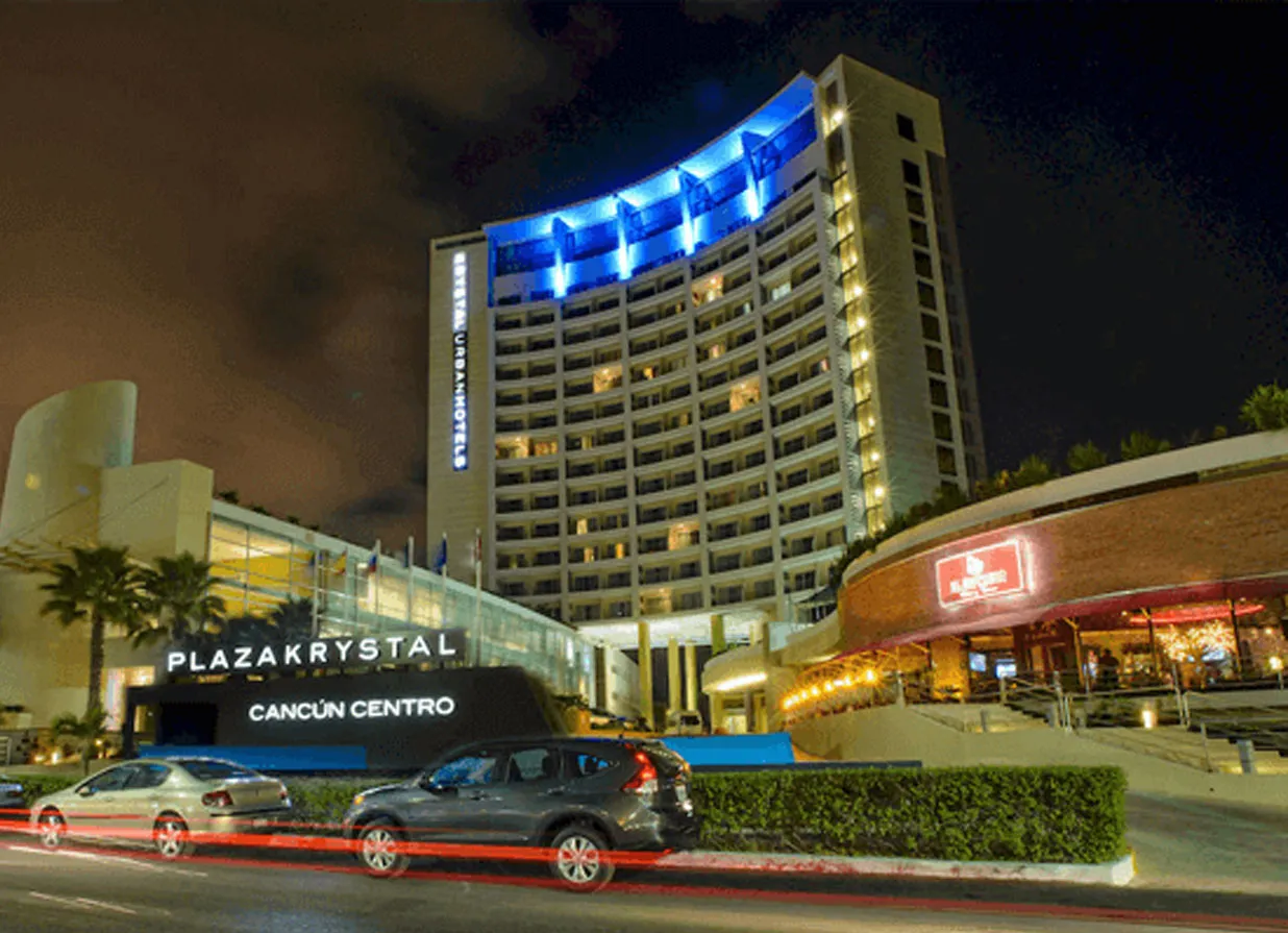 Cancun Downtown hotel with blue lights at night. One of the destinations available for Cancun Airport Transportation